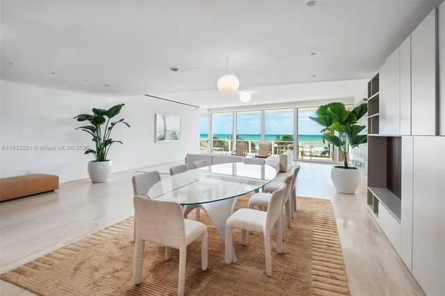 a dining room with furniture potted plants and wooden floor