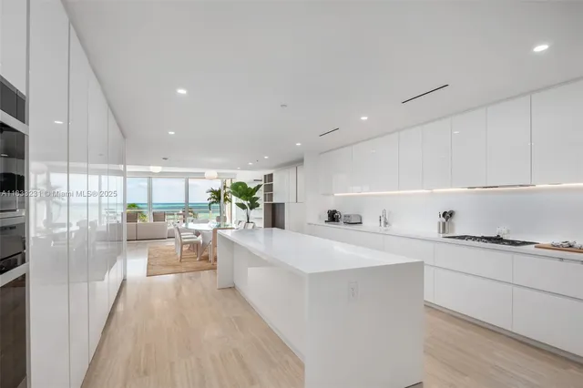 a large white kitchen with a lot of counter space