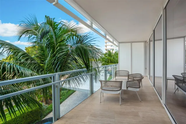 a view of a chair and tables in the balcony