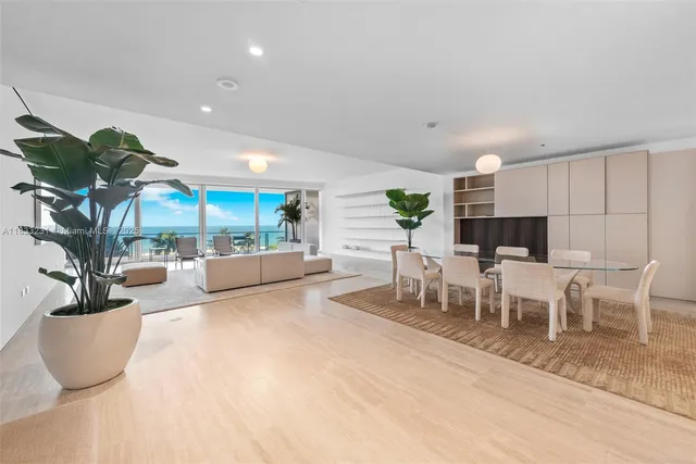 a view of a dining room with furniture and a potted plant