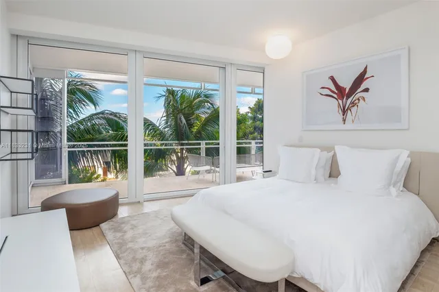 a spacious bedroom with a bed and a large window