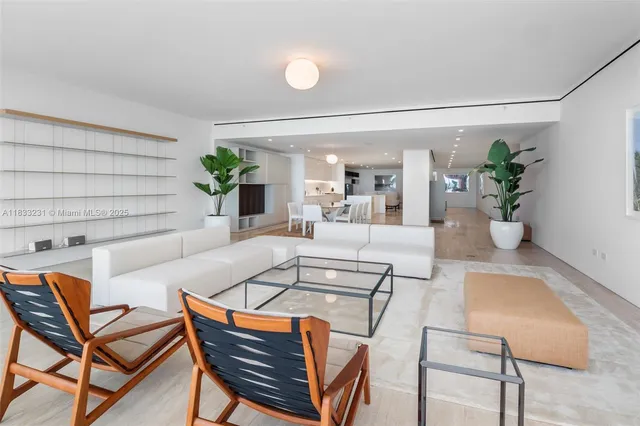 a view of a dining room with furniture and a potted plant