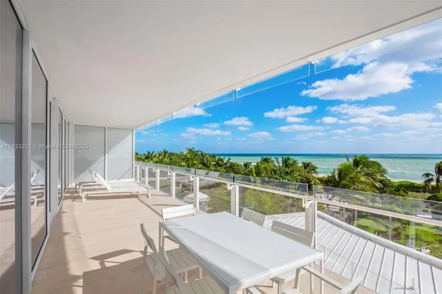 a view of a balcony with chair and a table