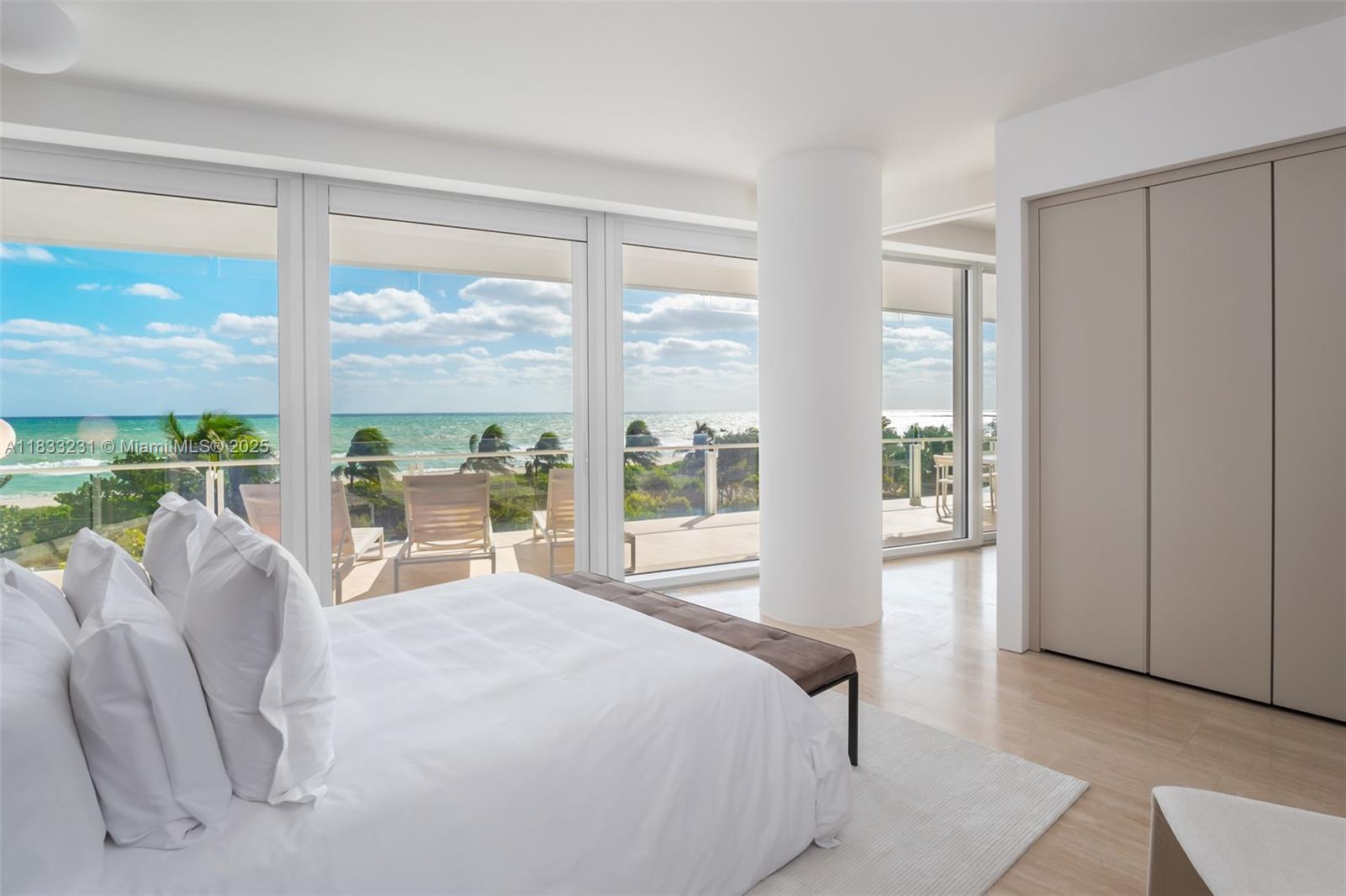 9001 Collins Avenue, Unit S305 Surfside, FL 33154 - Photo 8 of 23 a bedroom with a bed and a large window