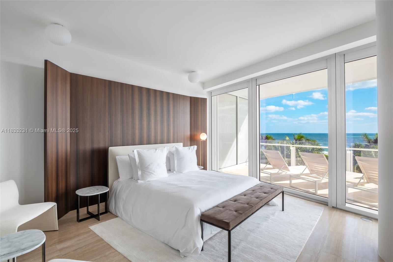 9001 Collins Avenue, Unit S305 Surfside, FL 33154 - Photo 9 of 23 a bedroom with a bed and a large window