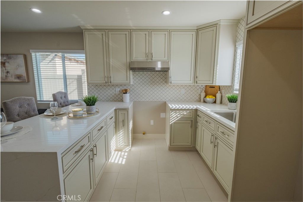 223 South Aprilia Avenue Compton, CA 90220 - Photo 32 of 46 a kitchen with a sink stove and cabinets
