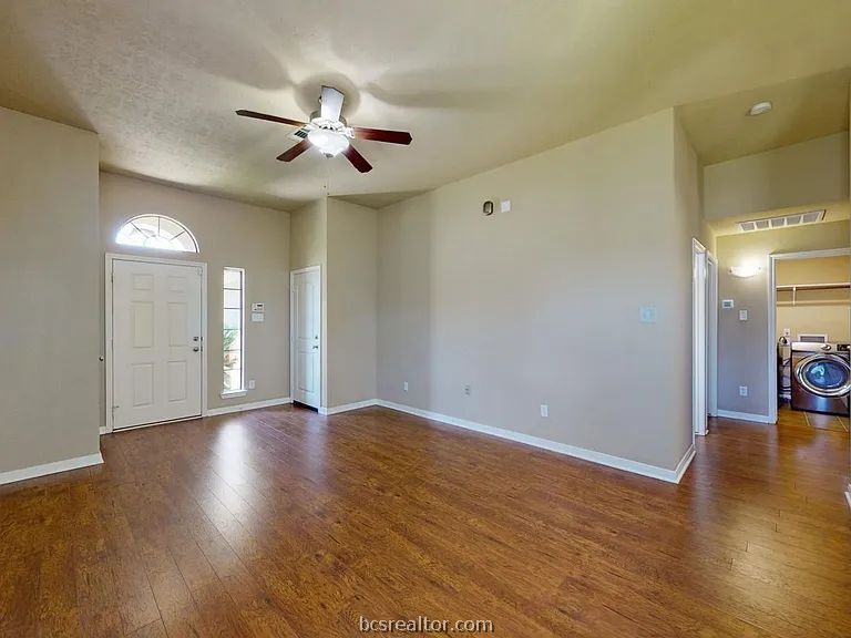 2024 Mountain Wind Loop Bryan, TX 77807 - Photo 3 of 14 a view of an empty room with wooden floor and a ceiling fan
