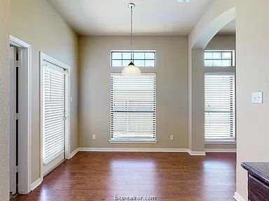 2024 Mountain Wind Loop Bryan, TX 77807 - Photo 5 of 14 an empty room with wooden floor and windows