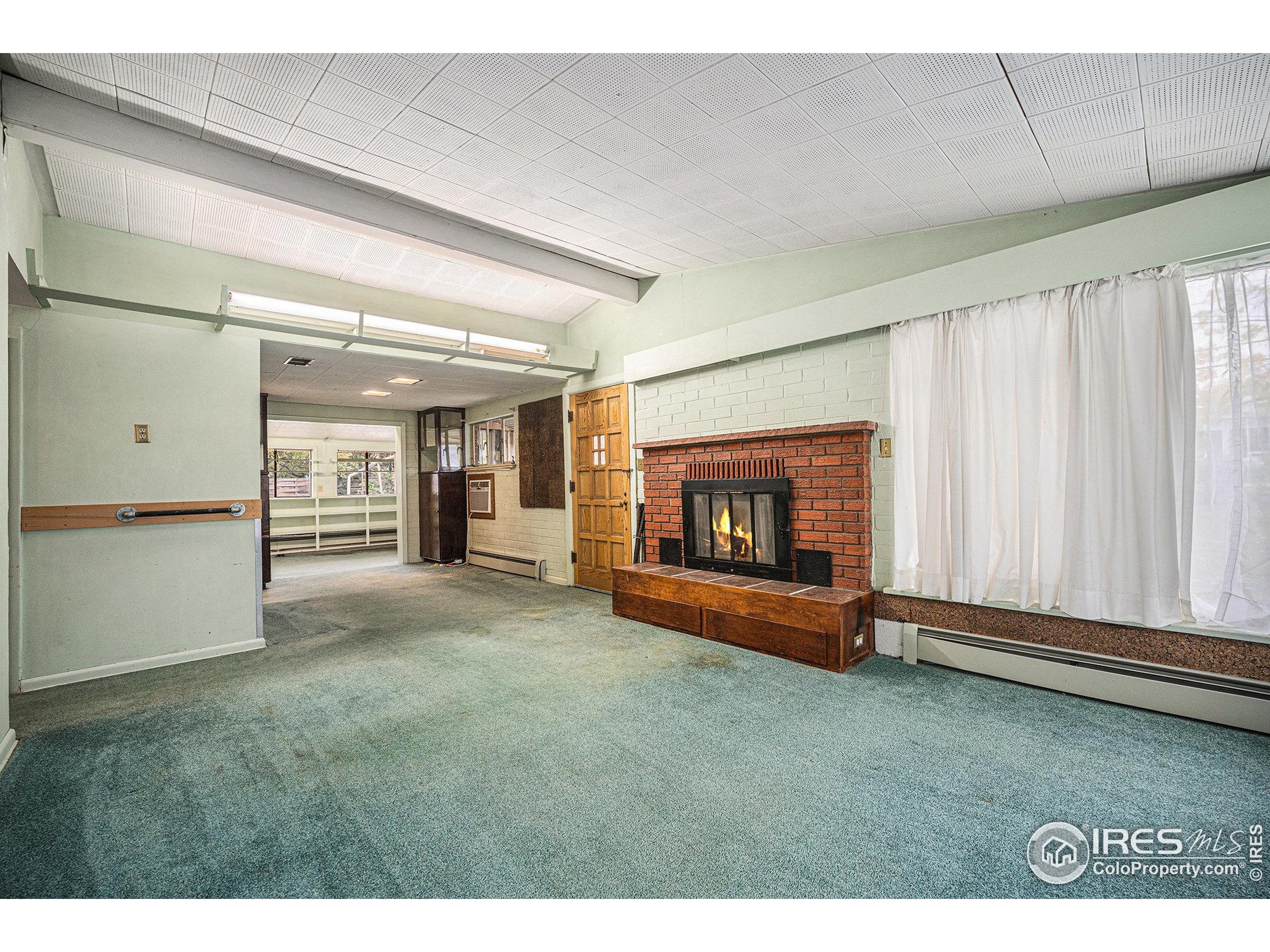 6137 Baseline Road Boulder, CO 80303 - Photo 10 of 40 a view of an empty room and fire place