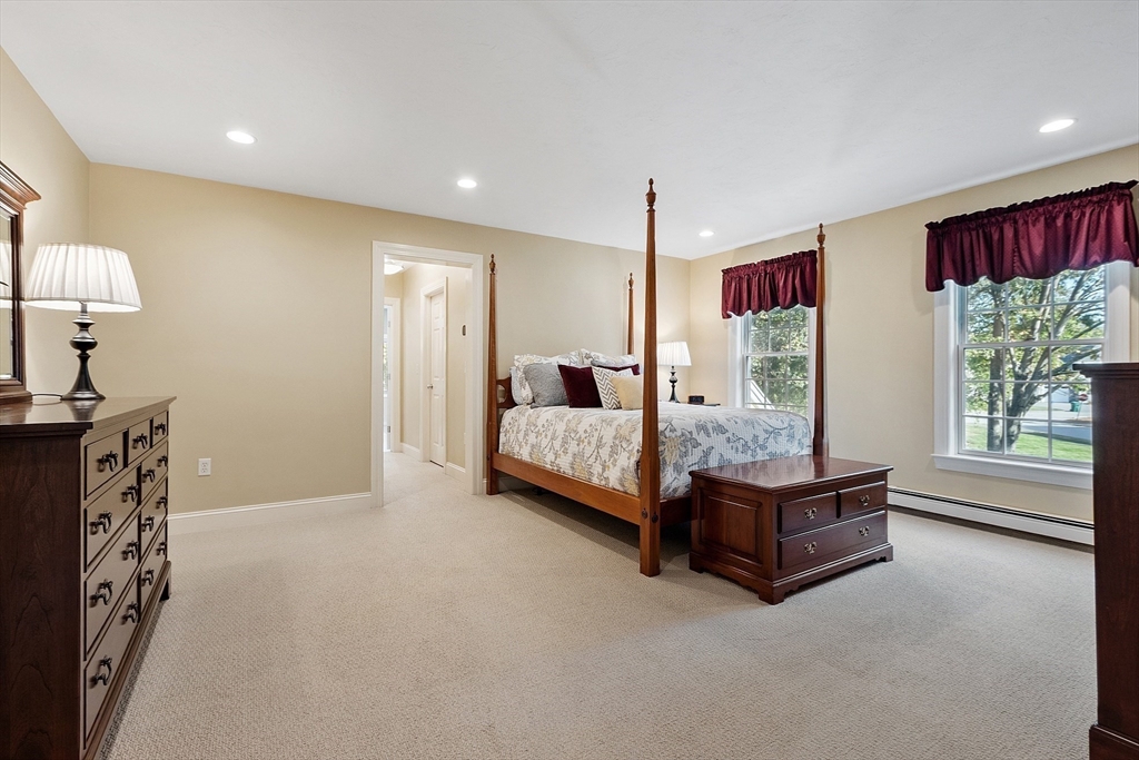 2 Taymax Road Westminster, MA 01473 - Photo 22 of 41 a spacious bedroom with a bed a chandelier and window
