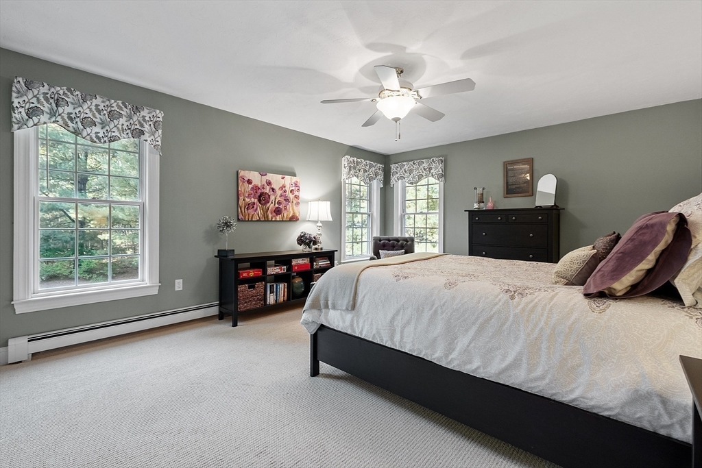 2 Taymax Road Westminster, MA 01473 - Photo 29 of 41 a spacious bedroom with a bed and a chandelier