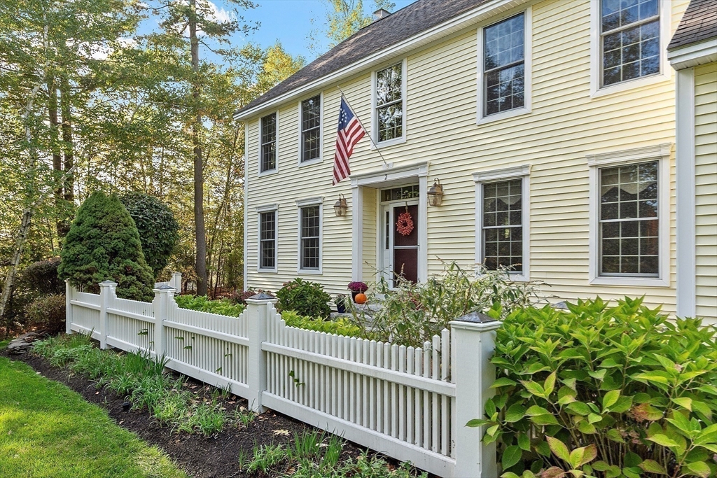 2 Taymax Road Westminster, MA 01473 - Photo 35 of 41 a view of a house with brick walls and a flower garden