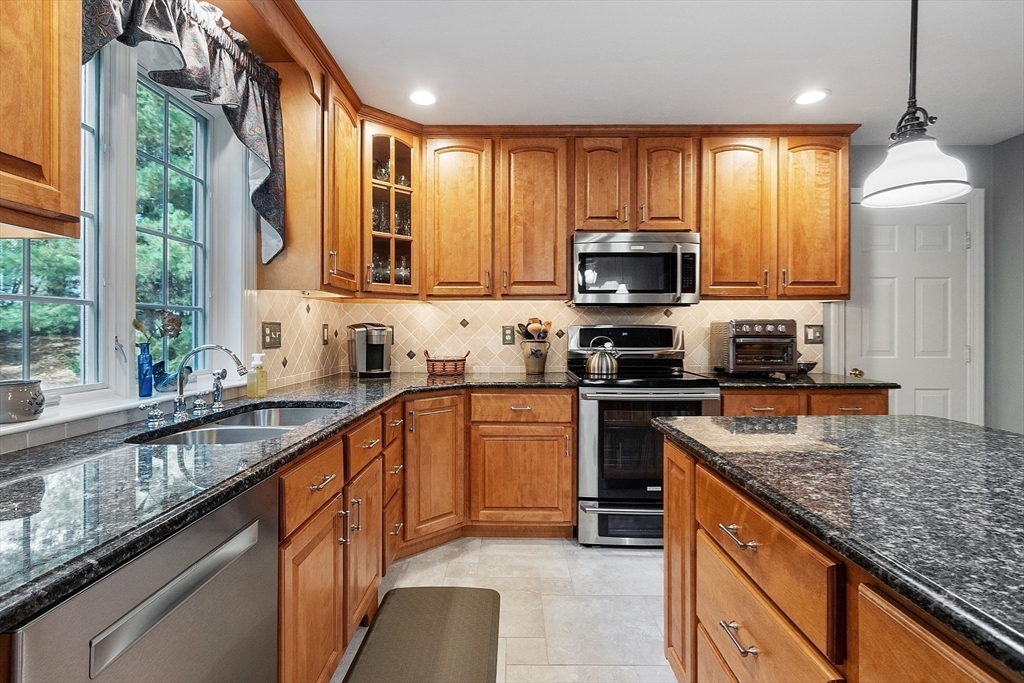 2 Taymax Road Westminster, MA 01473 - Photo 6 of 41 a kitchen with stainless steel appliances granite countertop wooden cabinets granite counter tops and a window