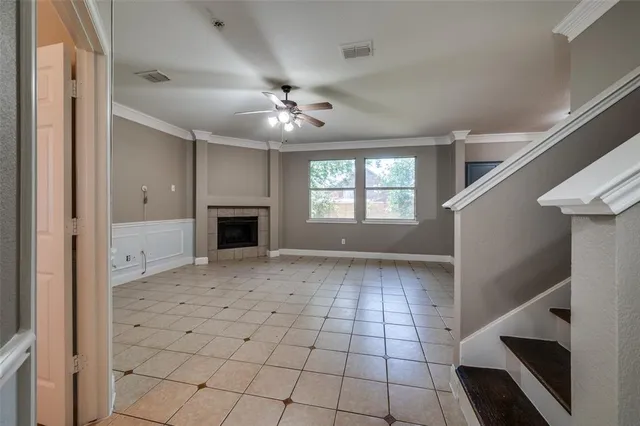a view of an empty room with a fireplace and a window