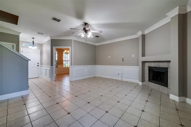 a view of an empty room and a kitchen