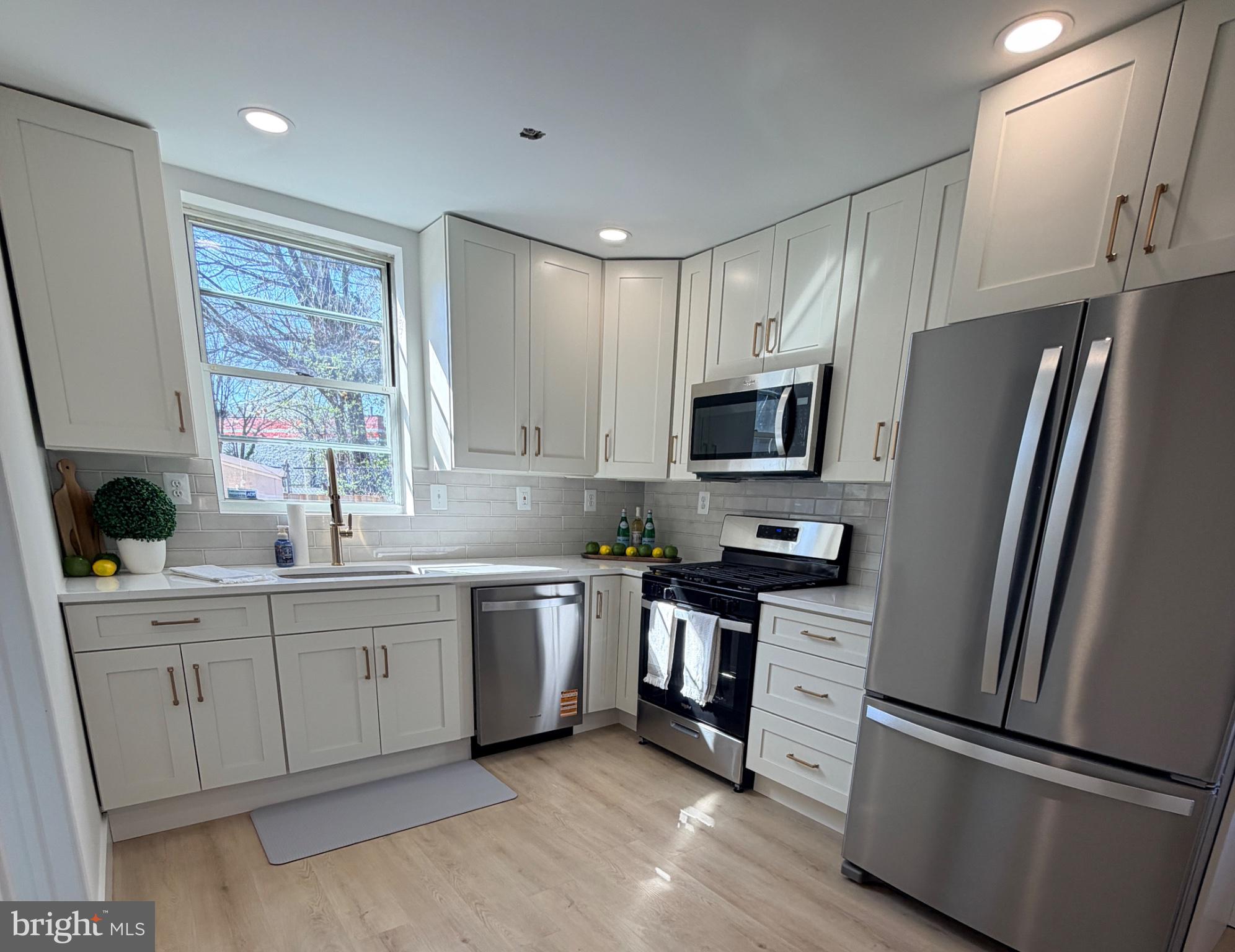 3650 Edison Street Alexandria, VA 22305 - Photo 2 of 3 a kitchen with stainless steel appliances granite countertop a refrigerator sink and stove