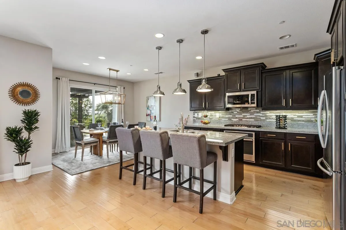 1014 Bellingham Drive Oceanside, CA 92057 - Photo 11 of 33 a large kitchen with a table and chairs