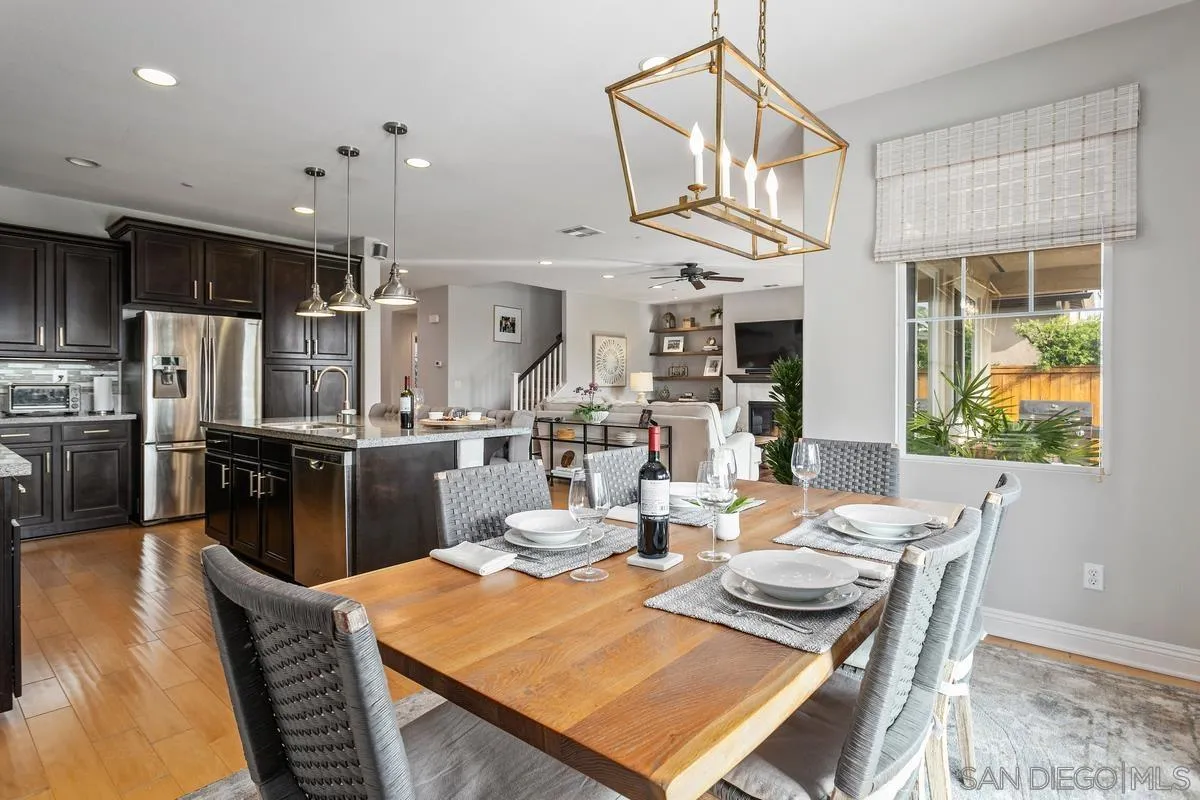 1014 Bellingham Drive Oceanside, CA 92057 - Photo 13 of 33 a view of a dining room with furniture a kitchen and chandelier