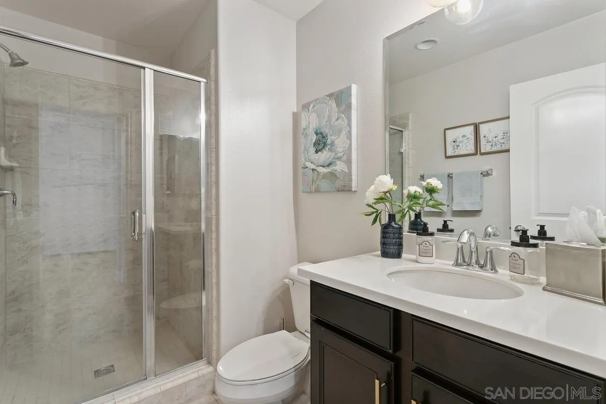1014 Bellingham Drive Oceanside, CA 92057 - Photo 16 of 33 a bathroom with a sink a toilet and shower