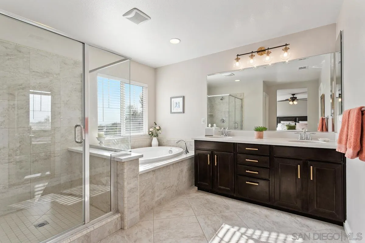 1014 Bellingham Drive Oceanside, CA 92057 - Photo 21 of 33 a spacious bathroom with a tub sink shower and mirror