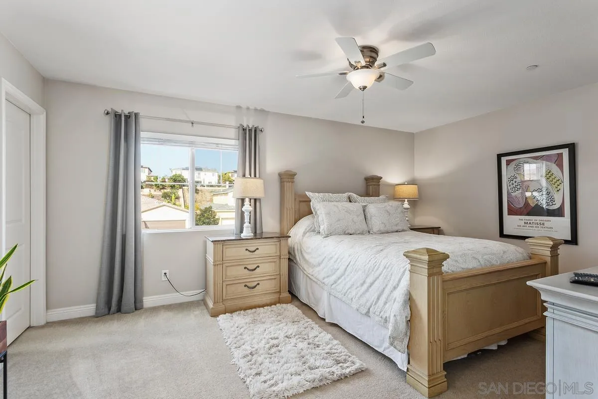 1014 Bellingham Drive Oceanside, CA 92057 - Photo 22 of 33 a bedroom with a bed and a chandelier
