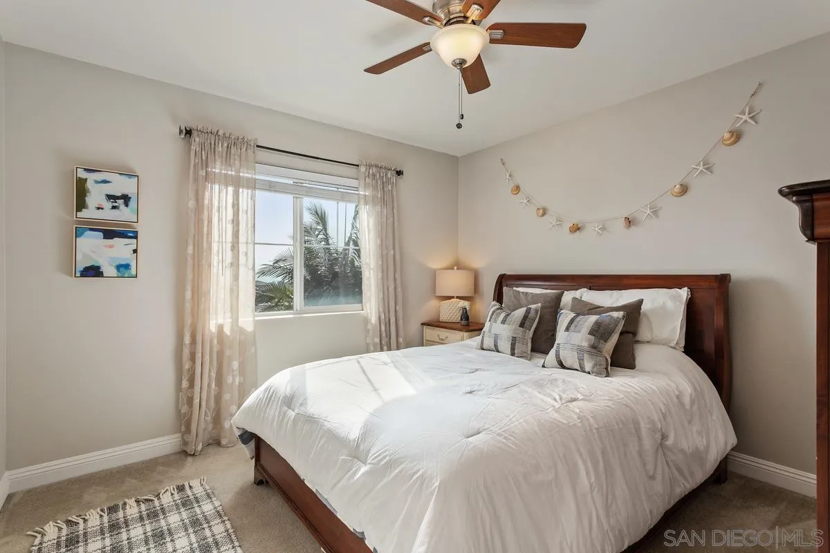 1014 Bellingham Drive Oceanside, CA 92057 - Photo 23 of 33 a bedroom with a large bed and a window