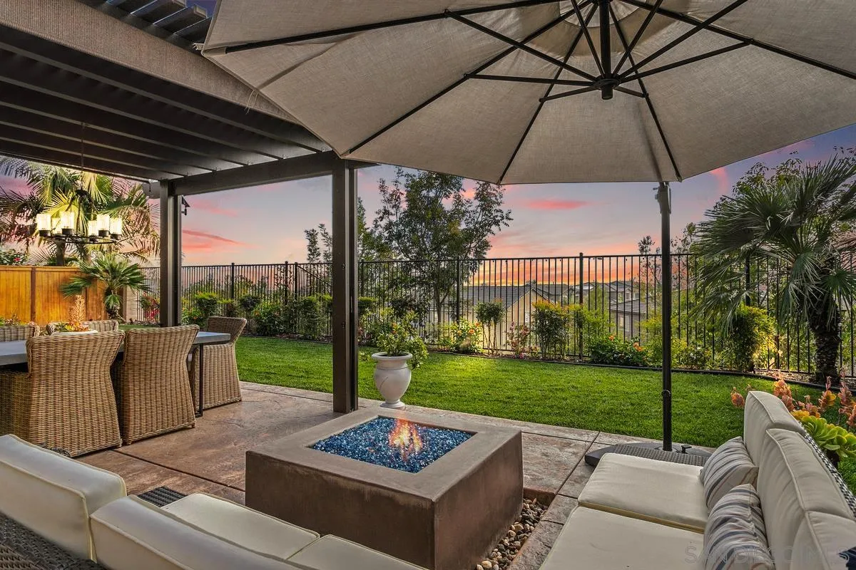 1014 Bellingham Drive Oceanside, CA 92057 - Photo 27 of 33 a patio with a table and chairs under an umbrella