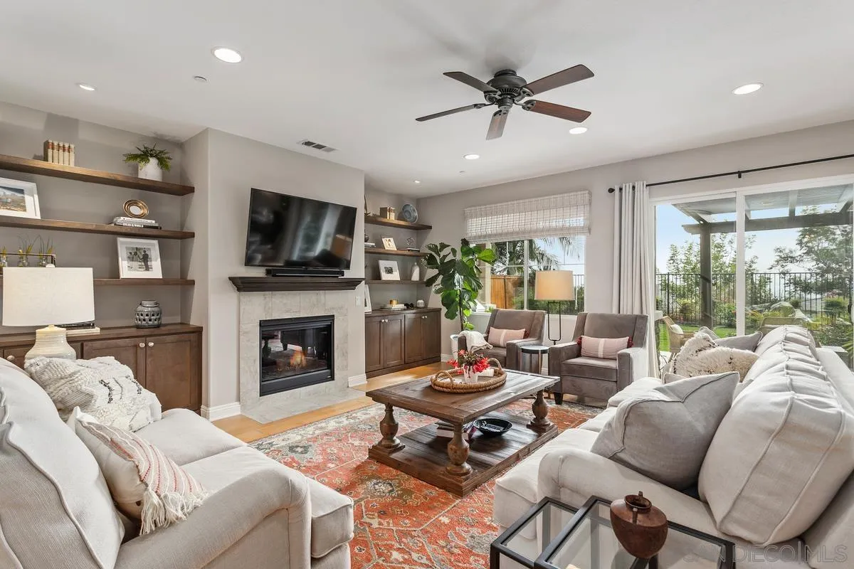 1014 Bellingham Drive Oceanside, CA 92057 - Photo 3 of 33 a living room with furniture a fireplace and a flat screen tv