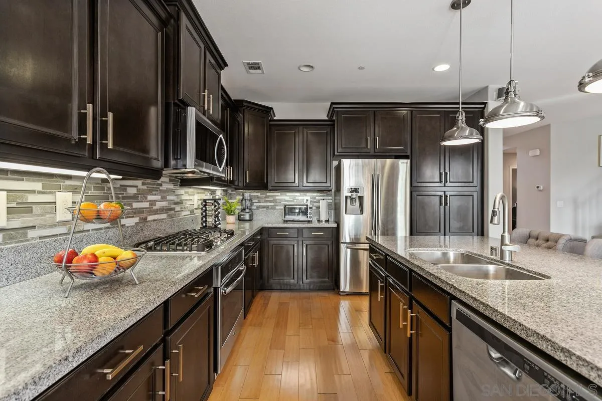 1014 Bellingham Drive Oceanside, CA 92057 - Photo 10 of 33 a kitchen with granite countertop a sink stove and refrigerator