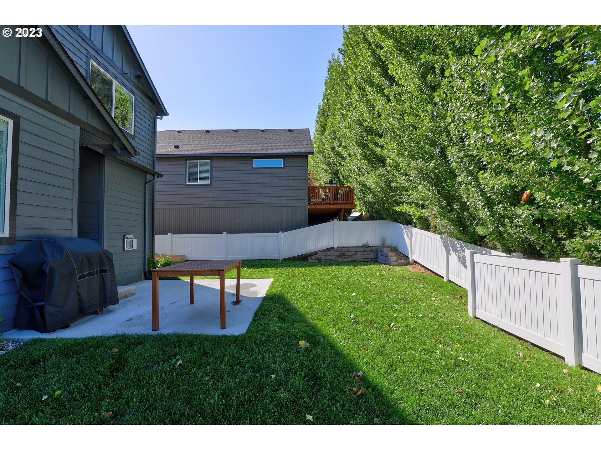 2601 Ericksen Way The Dalles, OR 97058 - Photo 37 of 37 a view of a backyard with table and chairs wooden fence