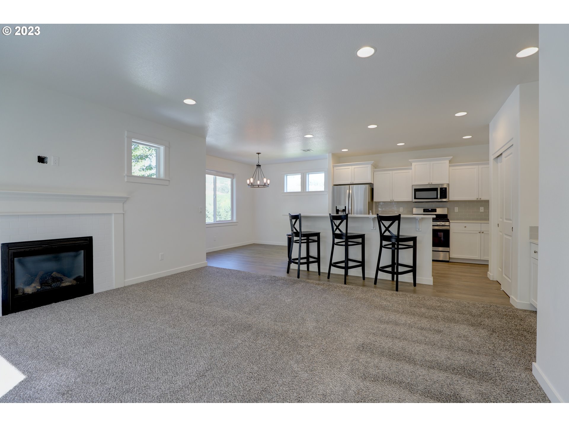2601 Ericksen Way The Dalles, OR 97058 - Photo 7 of 37 a view of a kitchen with chairs and a fireplace