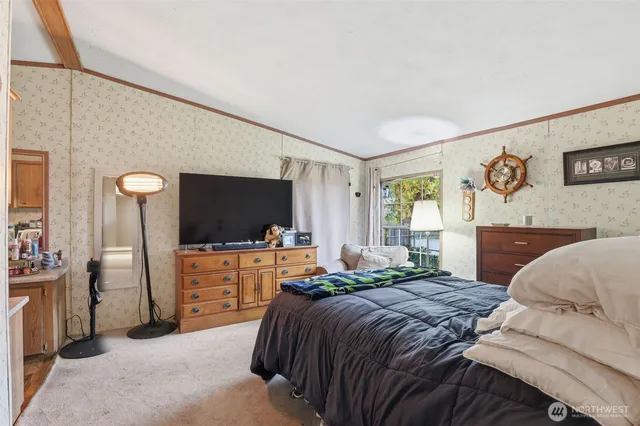 a bedroom with a bed and flat screen tv