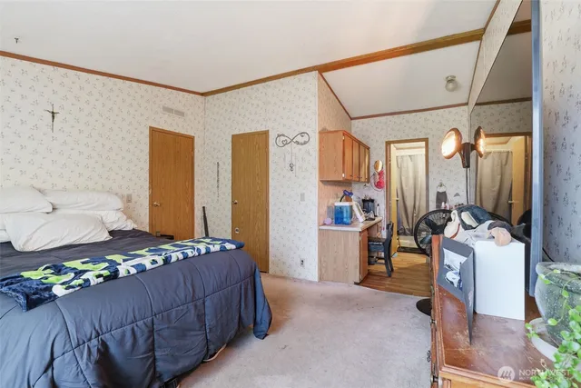 a bedroom with a bed and a mirror