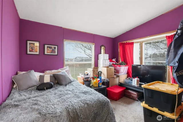 a bed room with a bed and a chair