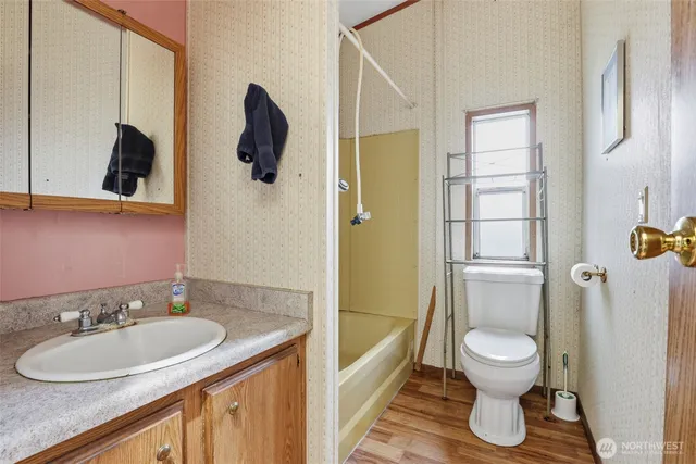 a bathroom with a toilet sink and mirror