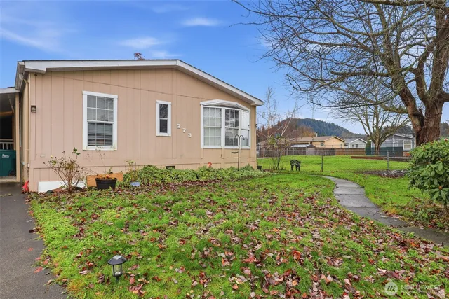 a front view of house with yard and green space