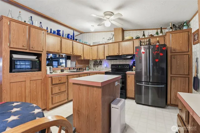 a kitchen with refrigerator cabinets and a sink