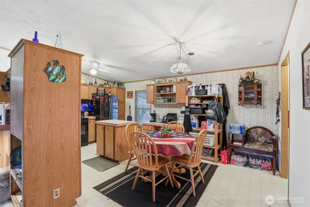 a dining room with lots of furniture and clutter