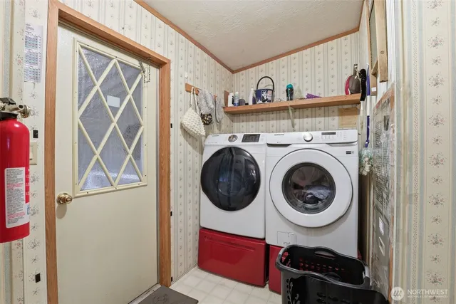 a view of storage and utility room with washer and dryer