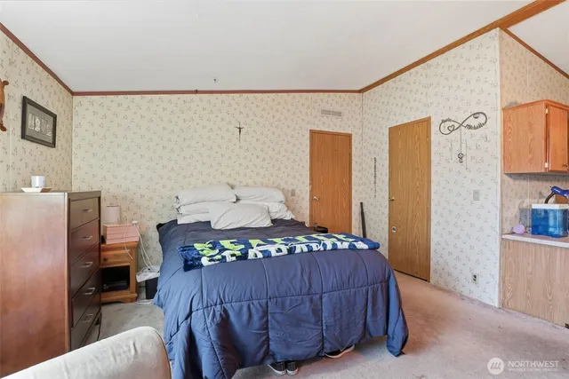 a bedroom with a bed and a cabinets