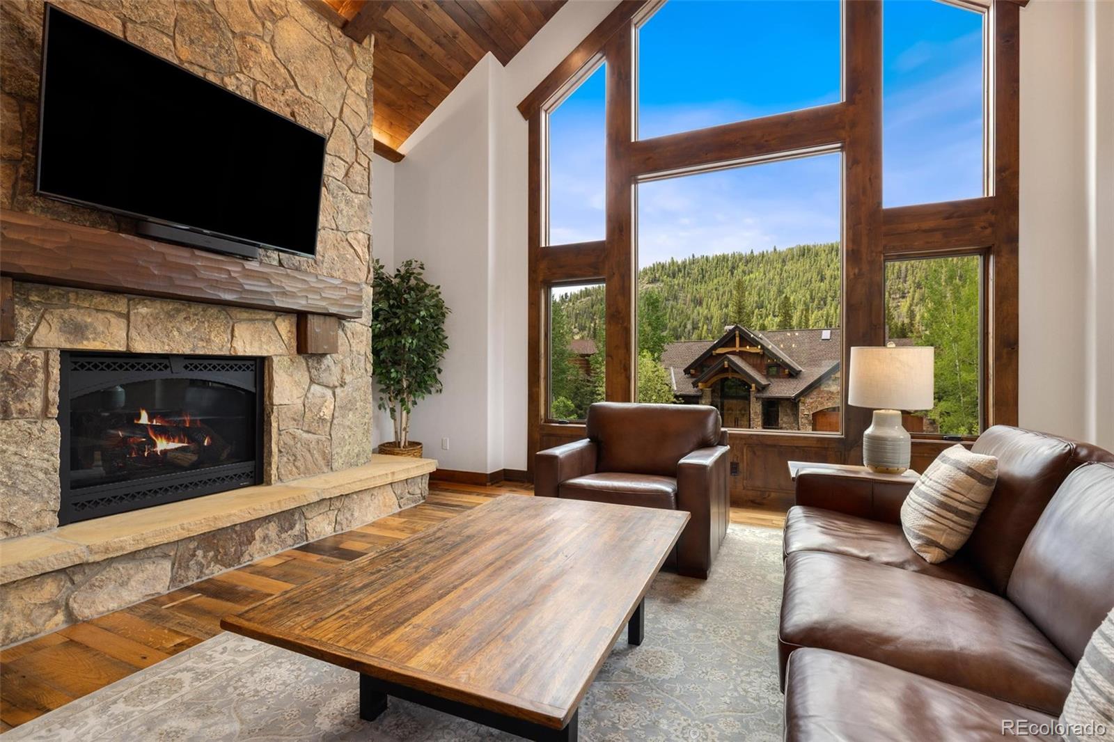 30 Wolf Rock Road Keystone, CO 80435 - Photo 6 of 39 a living room with furniture a flat screen tv and a fireplace
