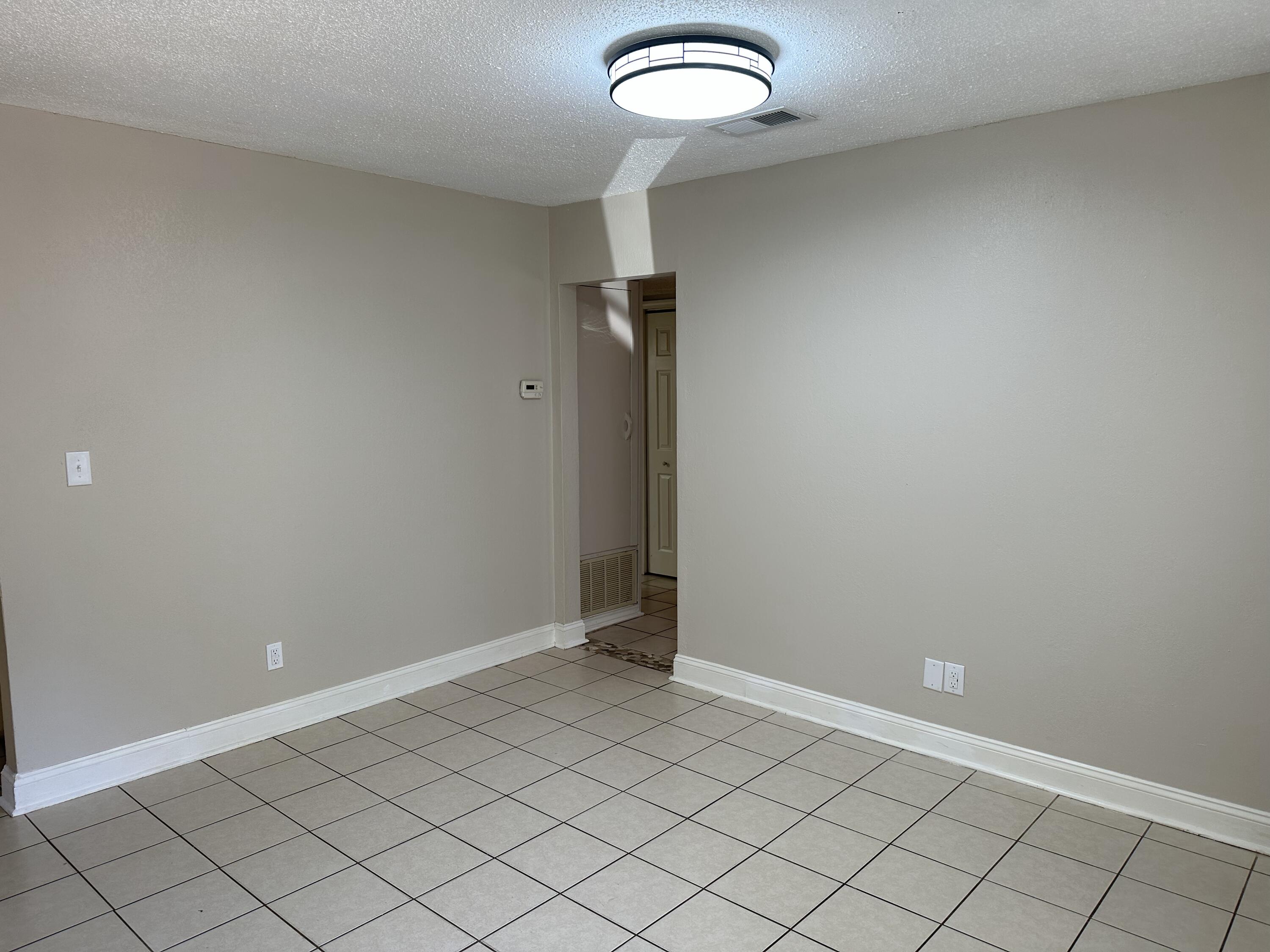 111 Sikes Drive Crestview, FL 32539 - Photo 2 of 20 an empty room with wooden floor