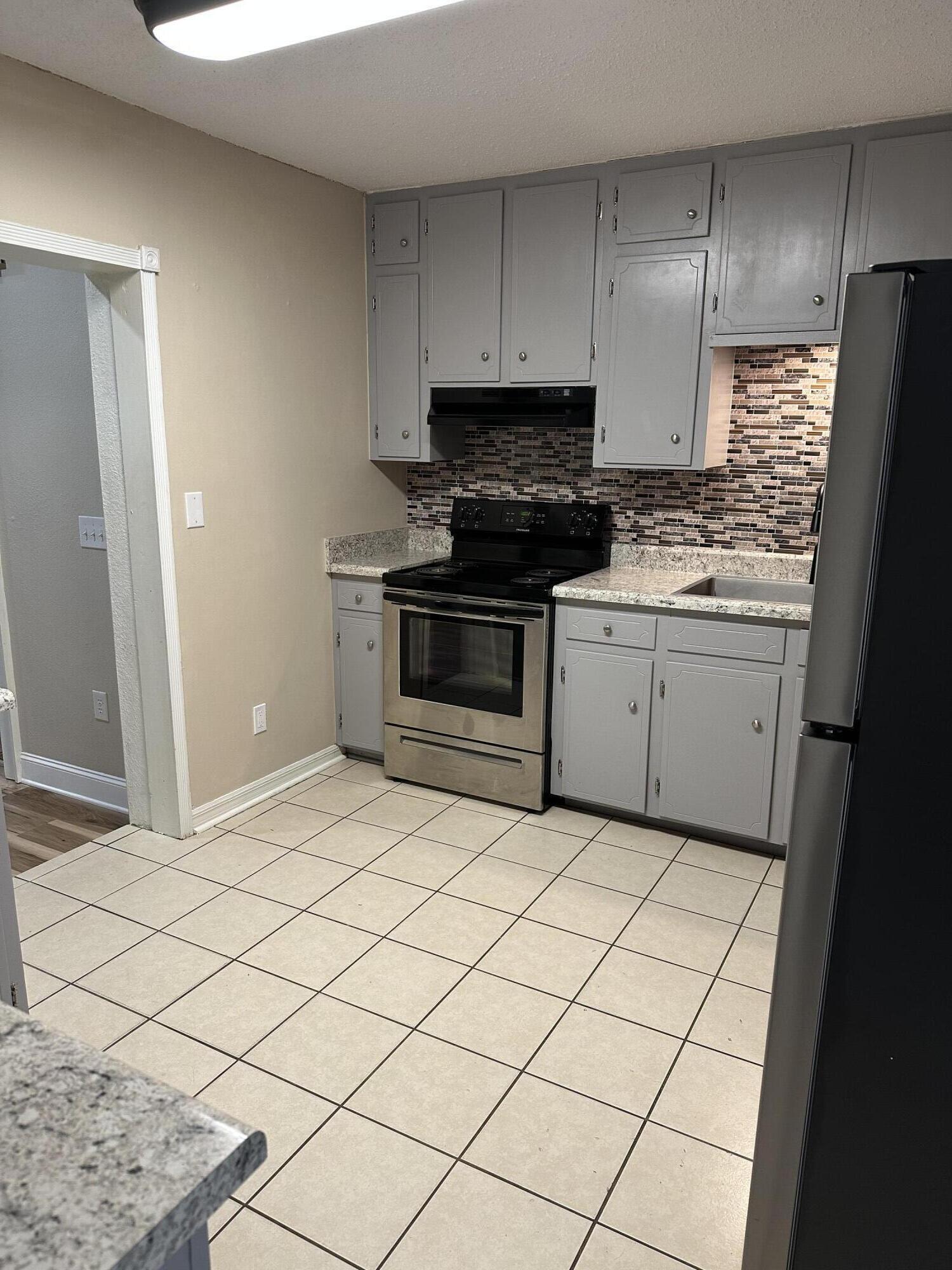111 Sikes Drive Crestview, FL 32539 - Photo 3 of 20 a kitchen with granite countertop white cabinets and stainless steel appliances