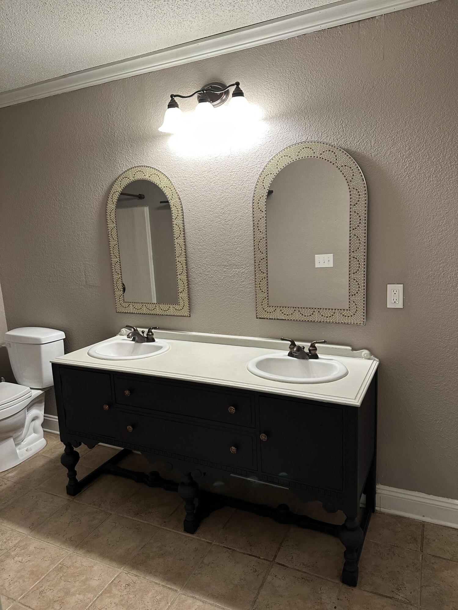 111 Sikes Drive Crestview, FL 32539 - Photo 10 of 20 a bathroom with a double vanity sink and a mirror