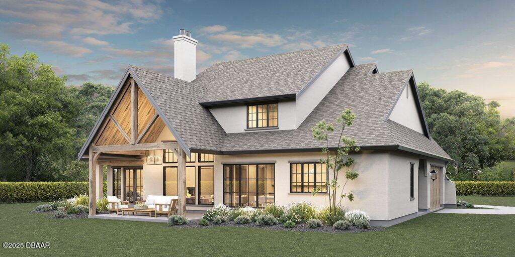 1104 Canopy Oak Lane Ponce Inlet, FL 32127 - Photo 2 of 6 a front view of a house with a yard