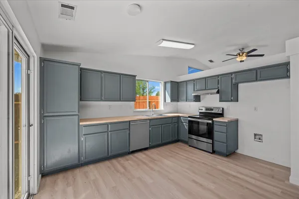 a kitchen with stainless steel appliances and a refrigerator