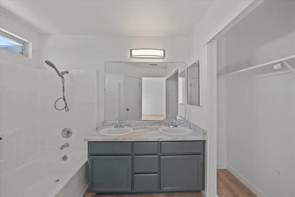 a bathroom with a sink a mirror and a bathtub