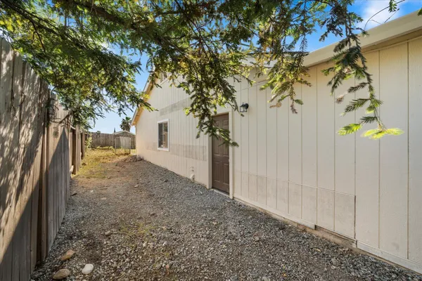a view of a house with a tree in the background