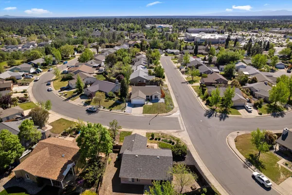 an aerial view of a house with a yard