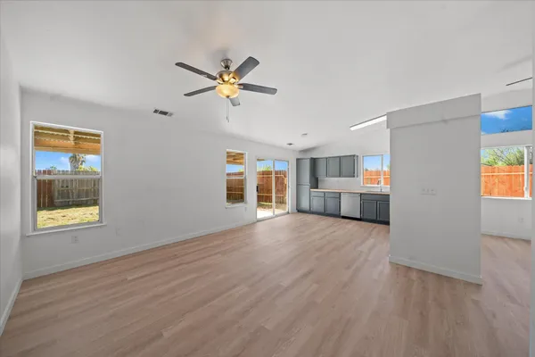 a view of empty room with wooden floor and window